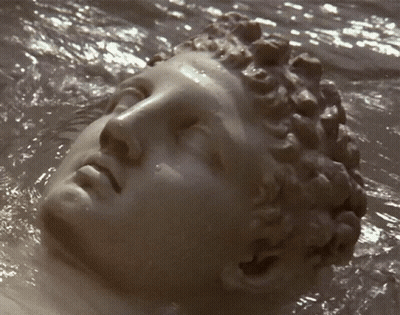 Statue Of Woman's Face Floating In Water GIF