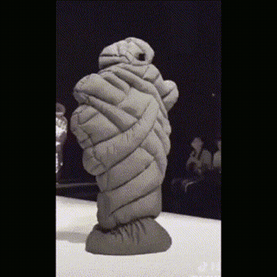 Statue Wrapped In Blanket Standing On Table GIF