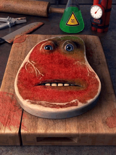 Steak With Face Painted On Wooden Cutting Board GIF