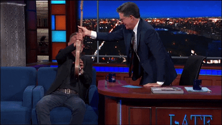 Stephen Colbert Getting Guitar From Bruce Springsteen GIF