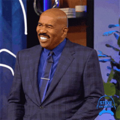 Steve Harvey Smiling In Suit And Tie GIF