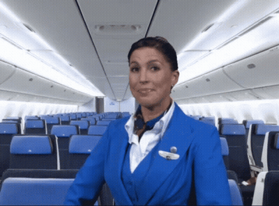 Stewardess Smiling In Blue Jacket GIF