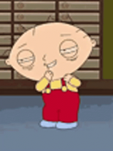 Stewie From Family Guy Is Standing In Front Of A Brick Wall And Smiling . GIF