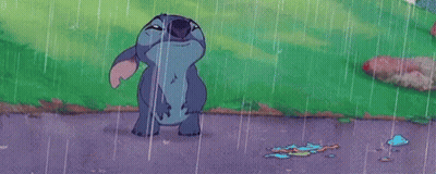 Stitch From Disney 'S Lilo And Stitch Is Standing In The Rain With His Mouth Wide Open . GIF