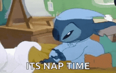 Stitch From Lilo And Stitch Is Laying In Bed Wearing A Nightcap . GIF