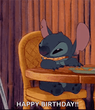 Stitch From Lilo And Stitch Is Sitting At A Table Eating A Sandwich . GIF