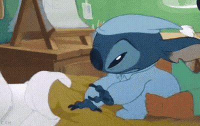 Stitch Laying On Bed Wearing Nightcap GIF