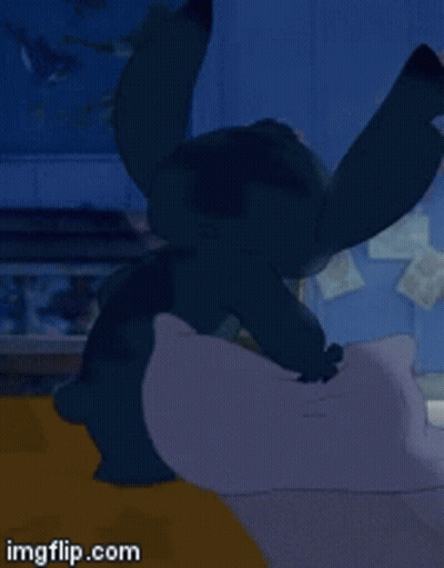 Stitch Laying On Bed With Pillow GIF