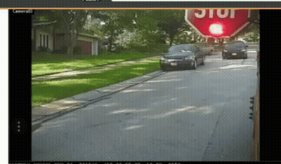 Stop Sign Above Street With Cars GIF