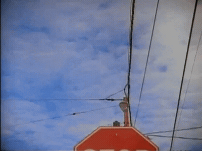 Stop Sign Hanging From Pole GIF