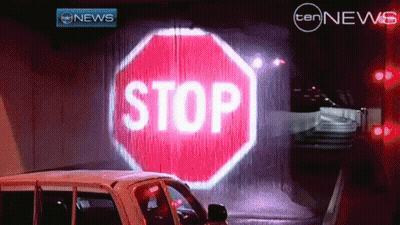 Stop Sign Projected On Wall With Ten News Logo GIF