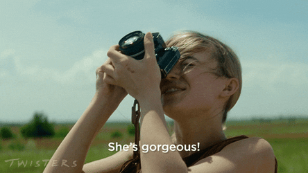 Storm Chaser Kate Carter Taking Photograph GIF