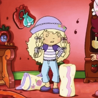Strawberry Shortcake Standing Next To Pillow GIF