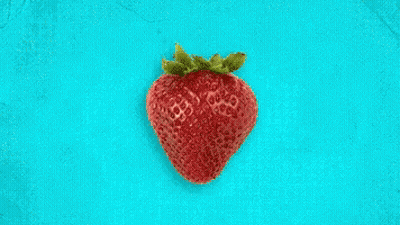 Strawberry Surrounded By Lemon And Grapefruit Slices On Blue GIF