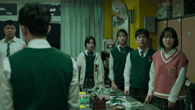 Students Standing Around Table With Vest Saying N GIF
