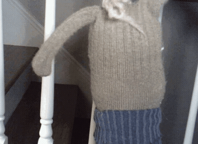 Stuffed Animal Hanging On Staircase Railing GIF