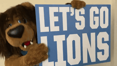 Stuffed Animal Holding Blue Sign Saying Let's Go Lions GIF
