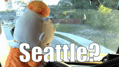 Stuffed Animal In Car With Seattle On Windshield GIF