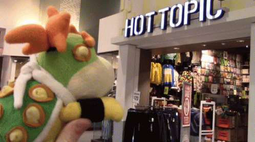 Stuffed Animal In Front Of Hot Topic GIF