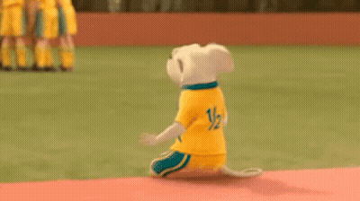 Stuffed Animal Kneeling In Field Wearing Yellow Shirt GIF