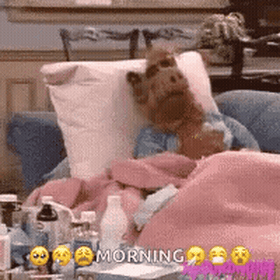 Stuffed Animal Laying In Bed With Napkin And Blanket GIF