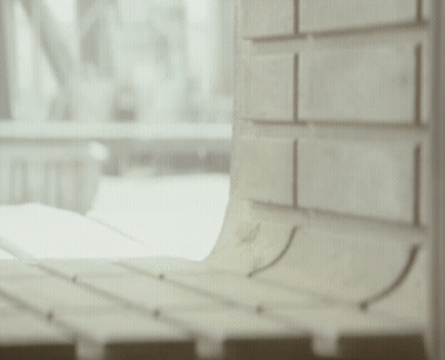 Stuffed Animal Next To Brick Wall Looking Out Window GIF