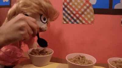 Stuffed Animal Pouring Cereal With Black Spoon GIF
