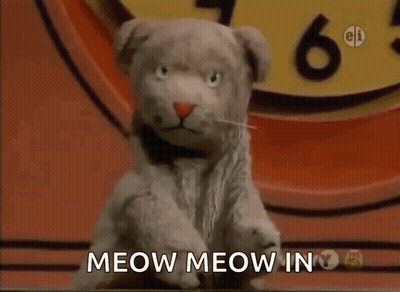 Stuffed Animal Saying Meow Meow In Front Of Clock GIF