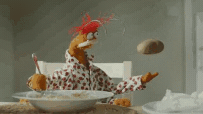 Stuffed Animal Sitting At Table With Cereal And Flying Potato GIF