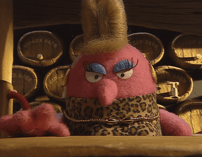 Stuffed Animal Sitting By Ginger Beer Barrels GIF