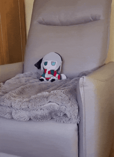Stuffed Animal Sitting In Chair With Blanket GIF