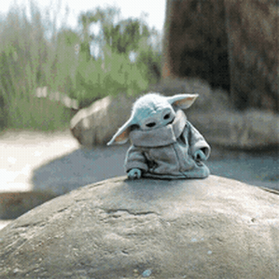 Stuffed Animal Sitting On Large Rock GIF