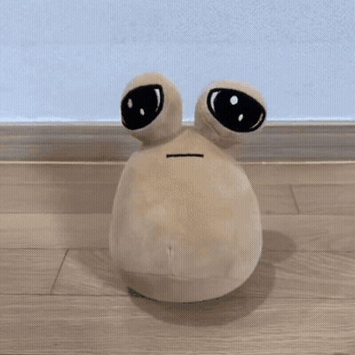 Stuffed Animal Sitting on Wood Floor
