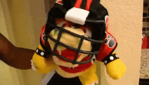 Stuffed Animal Wearing Football Helmet And Jersey GIF