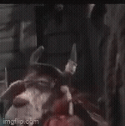 Stuffed Animal With Big Eyes And Horns Next To Person GIF