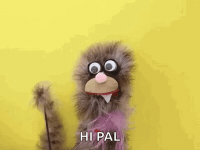 Stuffed Animal With Big Eyes And Purple Tail Waving GIF