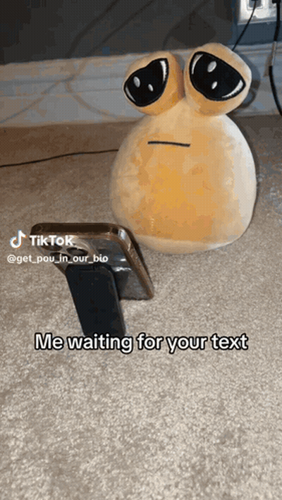 Stuffed Animal With Big Eyes Beside Phone GIF