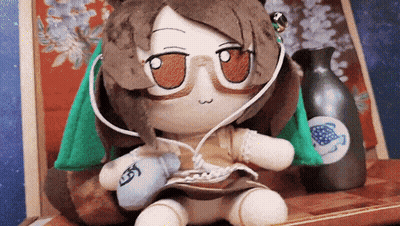 Stuffed Animal With Glasses And Headphones Next To Vase GIF