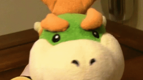Stuffed Animal With Green And Orange Face GIF