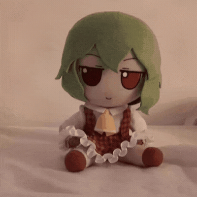 Stuffed Animal With Green Hair Sitting GIF