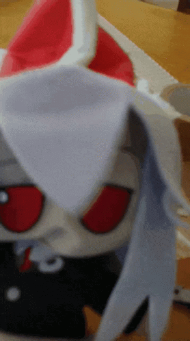 Stuffed Animal With Red Eyes On Table GIF