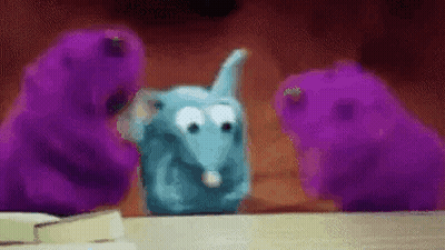 Stuffed Animals In Front Of Christmas Wreath GIF