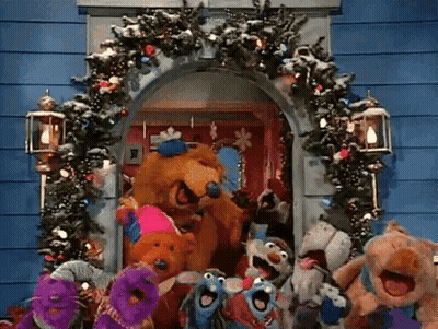Stuffed Animals In Front Of Christmas Wreath GIF