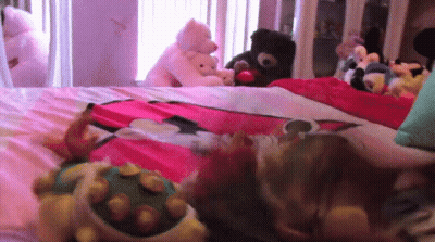 Stuffed Animals Laying On Bed Including Turtle GIF