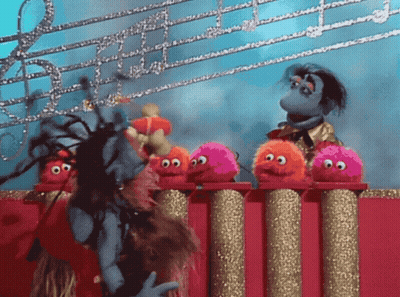Stuffed Animals On Podium, One With Dreadlocks GIF