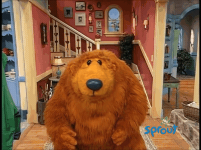 Stuffed Bear Standing In Front Of Sprout Sign GIF