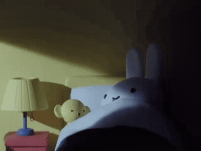 Stuffed Bunny Lying On Bed GIF