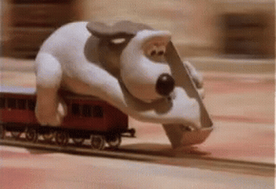 Stuffed Dog Jumping Over Toy Train GIF