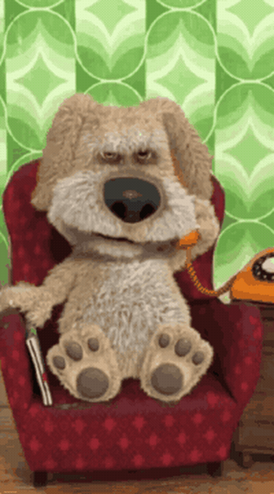 Stuffed Dog Sitting In Chair Talking On Phone GIF