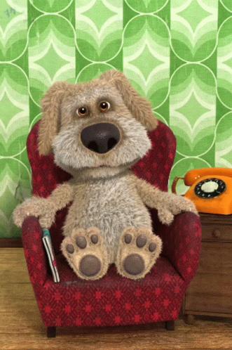 Stuffed Dog Sitting In Red Chair Next To Orange Phone GIF